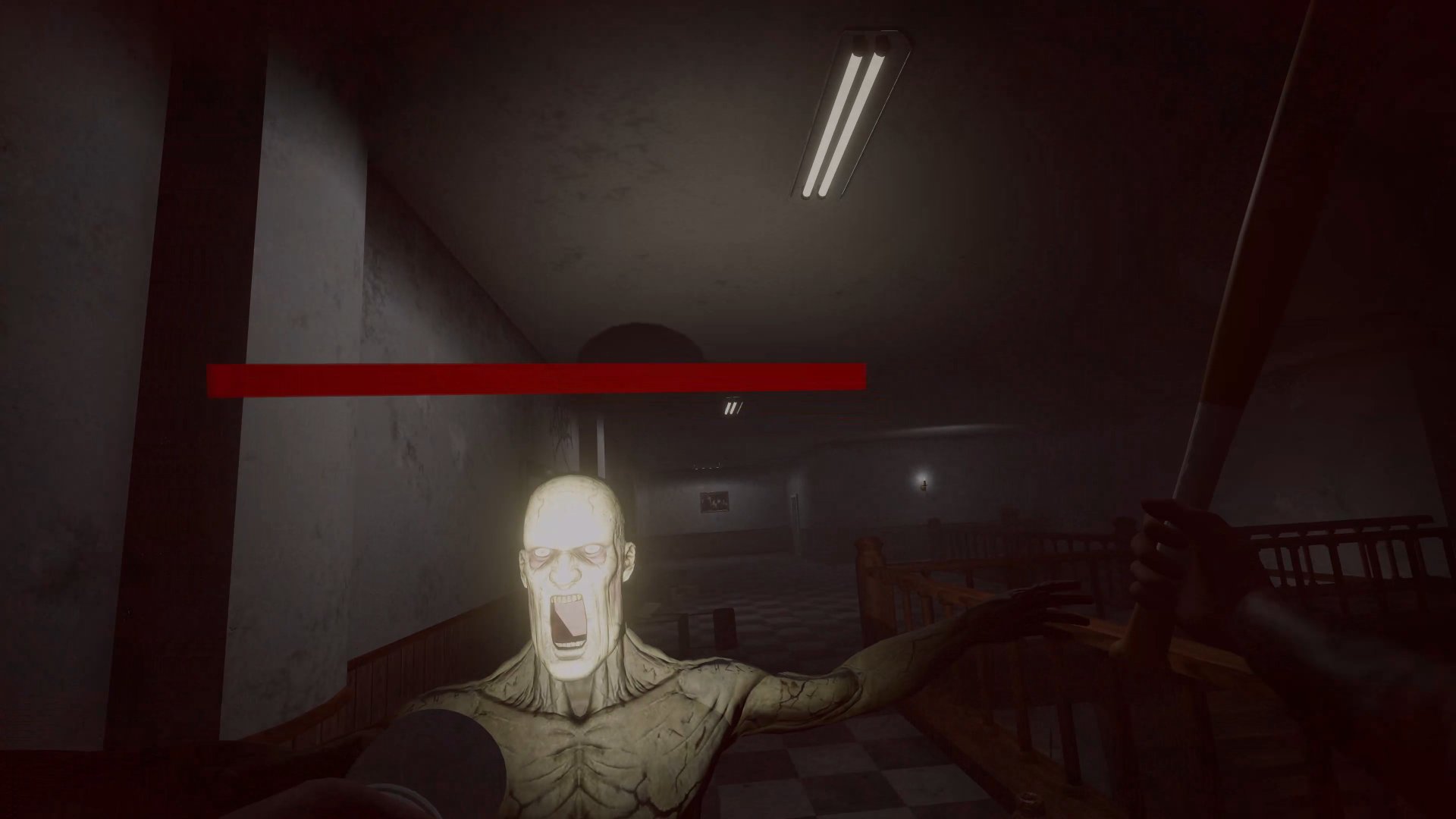 A screaming face lunging out of red light
